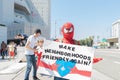 An activist holds a sign that says,