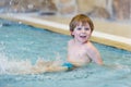 Activities on the pool, toddler boy swimming Royalty Free Stock Photo