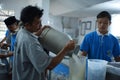 Activities of residents and employees are sorting cow`s milk