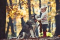 Activity and active rest. Red riding hood with wolf in fairy tale woods. Childhood, game and fun. Child play with husky