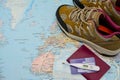 Walking boots on world map and face mask passport thermometer insurance card . Stop spreading coronavirus Royalty Free Stock Photo
