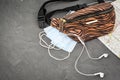 Wallet headphones on world map and face mask. Stop spreading coronavirus Royalty Free Stock Photo
