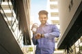 Businessman walking trough street checking the time. Royalty Free Stock Photo