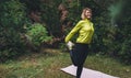 Activity girl exercising stretch legs outdoors in green park, Young fitness woman doing stretching exercises training outside Royalty Free Stock Photo