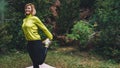 Activity girl exercising stretch legs outdoors in green park, Young fitness woman doing stretching exercises training outside Royalty Free Stock Photo