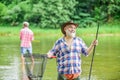 Activity and hobby. Happy cheerful people. Master baiter. Fisherman with fishing rod. Fishing freshwater lake pond river Royalty Free Stock Photo