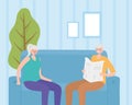 Activity seniors, old man reading newspaper and elderly woman sitting on sofa in the home Royalty Free Stock Photo