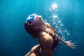 Activity woman with mask swimming underwater in sea, woman floats to the surface. Royalty Free Stock Photo