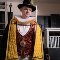 Actor dressed historical costume in interior of old theater.