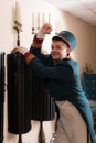 Actor dressed historical costume in interior of old theater.