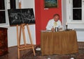 Actor in historical costume with blackboard