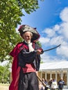 Actor man in historical pirate costume making a show outdoors