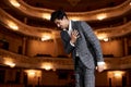 Actor or opera singer bow down after performance, expressing gratitude, looking pleasant