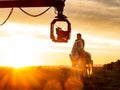 Actor riding a horse during the filming of a sequence for a television series,with camera on crane