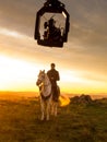 Actor riding a horse during the filming of a sequence for a television series,with camera on crane