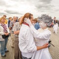 actor of the St. Petersburg Theater Non Stop Theater after a street performance hugs a fan on the waterfront at the festival `Vol