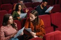 Actors and actresses reading scripts on