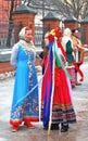 Actors dressed in colorful national costumes greet people on the street.