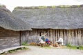 Actors dressed in middle age viking attires and performing daily activities of viking villagers in Viking Haithabu village