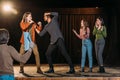 Actors rehearsing fight on stage in