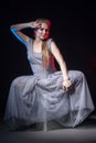 Actress in a grey dress on a dark stage Royalty Free Stock Photo