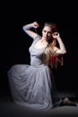 Actress in a grey dress on a dark stage Royalty Free Stock Photo