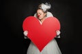 Actress lady in clown costume with red heart on black background Royalty Free Stock Photo