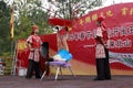 Actress performing acrobatics, kicking wooden table