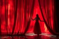 Actress is standing on a stage, opening a red curtain Royalty Free Stock Photo
