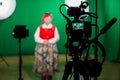 Actress in theatrical costume in a television Studio. Green screen and chroma key. Lighting equipment and filming equipment Royalty Free Stock Photo