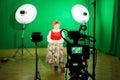 Actress in theatrical costume in a television Studio. Green screen and chroma key. Lighting equipment and filming equipment