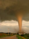 Actual photo of a tornado illuminated by the setting sun touching down in Iowa, narrowly missing a farm. Royalty Free Stock Photo