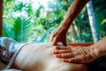 Acupressure massage in spa centre outdoor. Woman at acupressure back massage, masseur`s hands close up. Body therapy for healthy Royalty Free Stock Photo