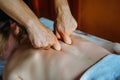 Acupressure massage in spa centre. Woman at acupressure back massage, masseur`s hands close up. Body therapy for healthy life Royalty Free Stock Photo