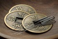 Acupuncture needles and Chinese coins in wooden bowl, closeup Royalty Free Stock Photo