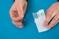 Acupuncture needles in doctor hands holding blister