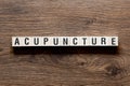 Acupuncture - word concept on building blocks, text