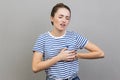 Woman clutching breast and grimacing from painful cramp, heart attack at young age, cardiac disease. Royalty Free Stock Photo