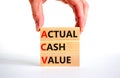 ACV actual cash value symbol. Concept words ACV actual cash value on blocks on a beautiful white table, white background.