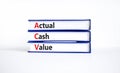 ACV actual cash value symbol. Concept words ACV actual cash value on books on a beautiful white table, white background. Business