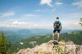 Aczive young amn gesture success after climbing a mountain