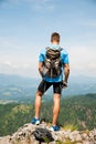 Aczive young amn gesture success after climbing a mountain