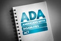 ADA - Americans with Disabilities Act acronym on notepad, concept background