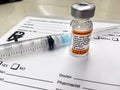 Adacel vaccine on prescription pad with needle