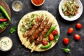 Adana Kebab with fresh vegetables on flatbread Royalty Free Stock Photo