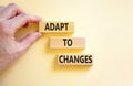 Adapt to changes symbol. Concept words Adapt to changes on wooden blocks. Businessman hand. Beautiful white table white background Royalty Free Stock Photo