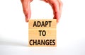 Adapt to changes symbol. Concept words Adapt to changes on wooden blocks. Businessman hand. Beautiful white table white background Royalty Free Stock Photo