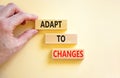 Adapt to changes symbol. Concept words Adapt to changes on wooden blocks. Businessman hand. Beautiful white table white background Royalty Free Stock Photo