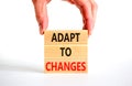 Adapt to changes symbol. Concept words Adapt to changes on wooden blocks. Businessman hand. Beautiful white table white background Royalty Free Stock Photo