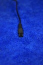 Adapter charger for head torch, black on blue microfiber cloth